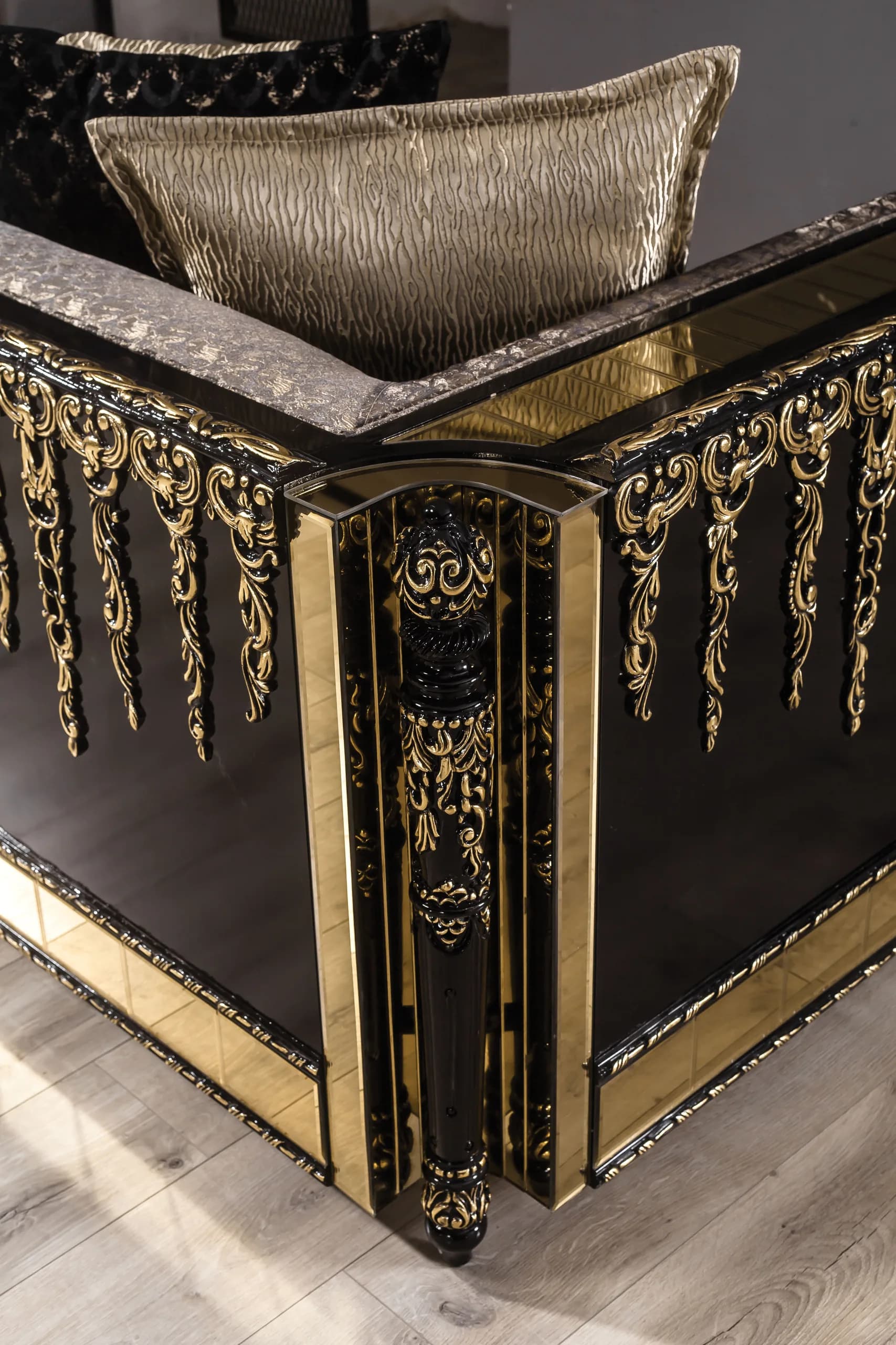Close detail of gold banding and faceted relief on a lacquer panel