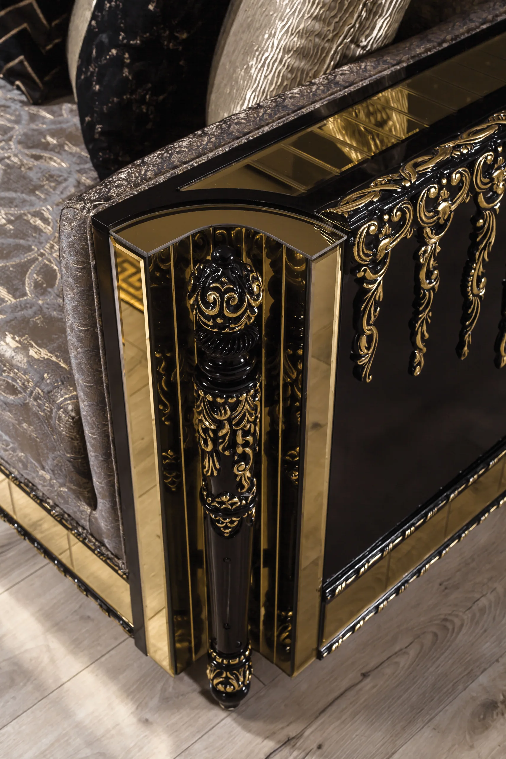 Close detail of gold banding and faceted relief on a lacquer panel